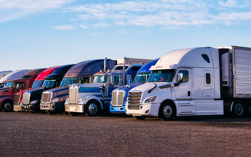 Fleet of M&K Transportation trucks lined up at a distribution yard